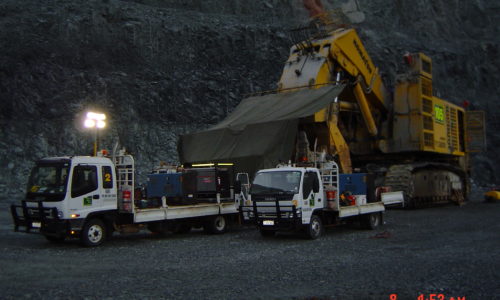 Two boilermaking service trucks providing equipment for servicing Komatsu PC8000 shovel during night shift