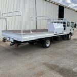 Light duty truck with custom built tray including tool cabinet behind door and pull out drawer underneath